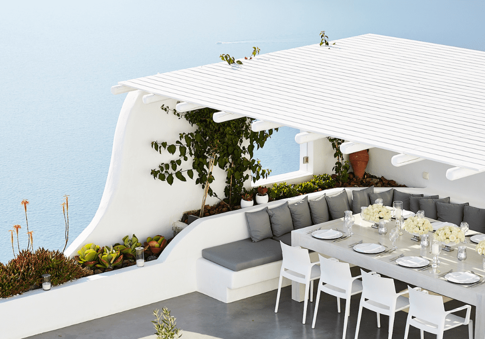 A beautifully arranged table on the terrace with an ocean view, perfect for a private wedding at Erossea Villa Santorini