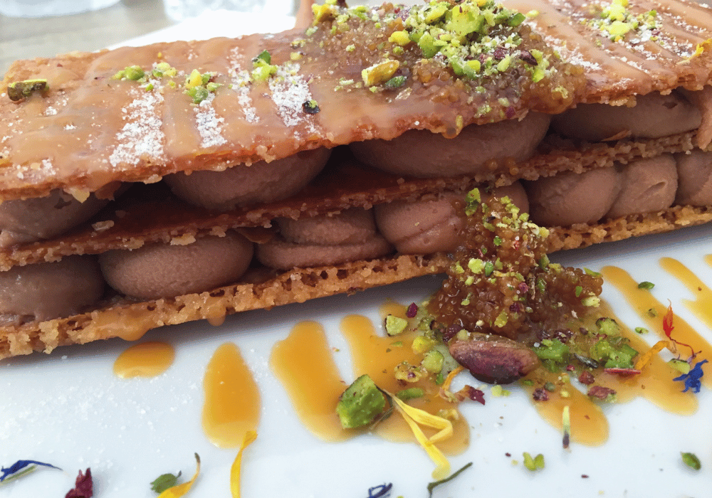 A beautifully arranged plate featuring Santorini baklava, highlighting its rich layers of pastry and sweet honey glaze