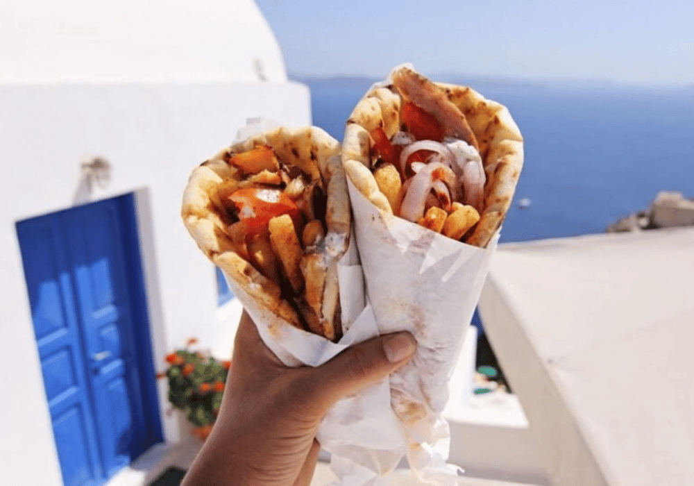 . An enticing set of gyros representing Greek food, showcased in the beautiful setting of Oia, Santorini, Greece