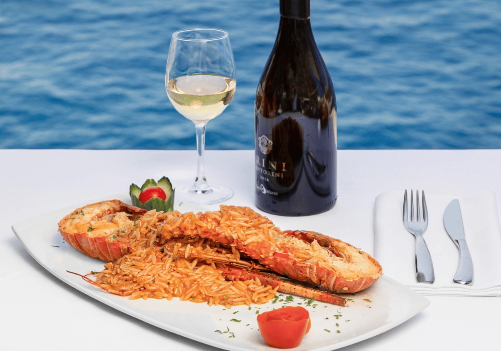 A delightful plate of food paired with a bottle of wine on a table, capturing the essence of dining in Santorini